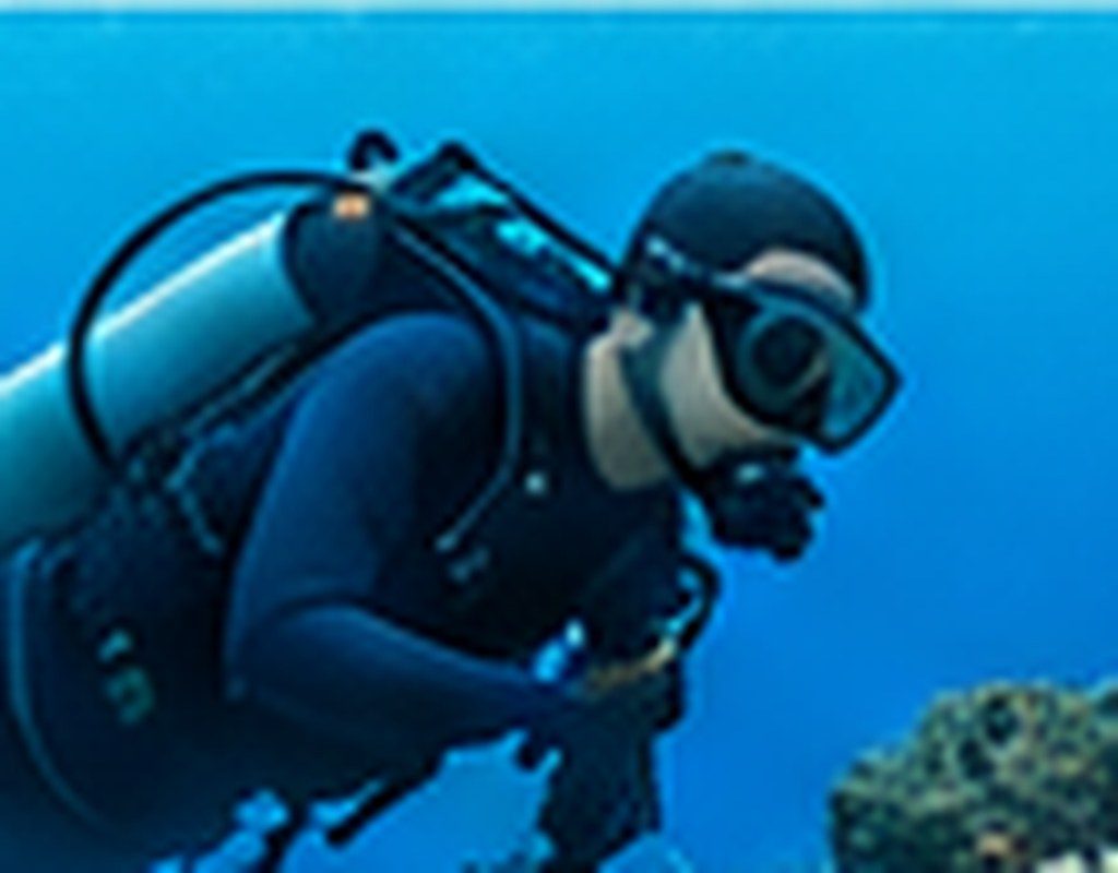 Scuba diver exploring underwater in Kauai