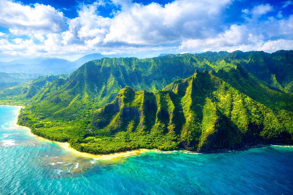 Kauai’s green mountains, sandy coastline and turquoise ocean