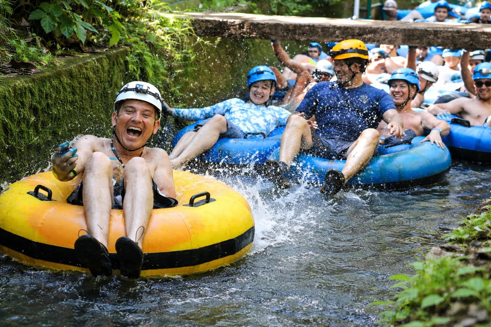 Guests floating in inner tubes through a Kauai waterway
